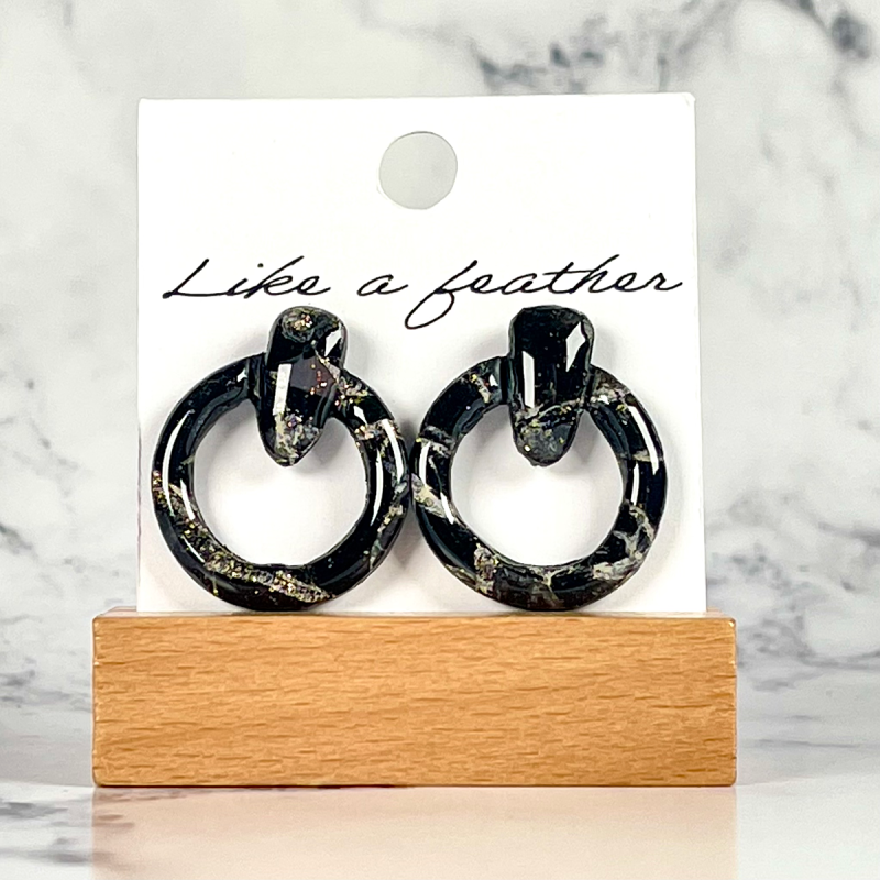 stud earrings shaped like circle door knocker, in black, whi