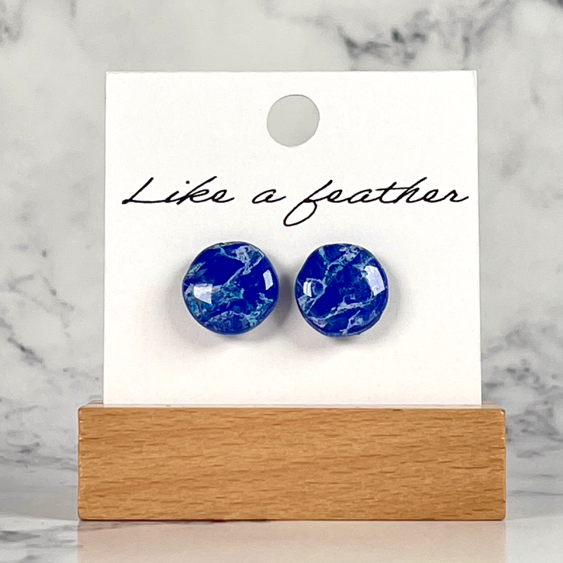 stud earrings shaped like circle, in blue, white colors.