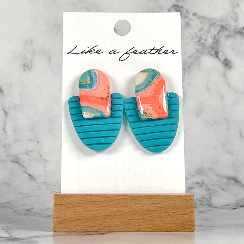 stud earrings shaped like two opposing half-ovals, in blue,