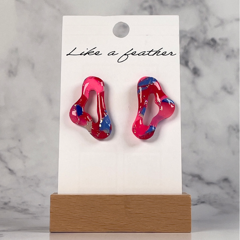 stud earrings shaped like organic, in red, neon pink, blue a