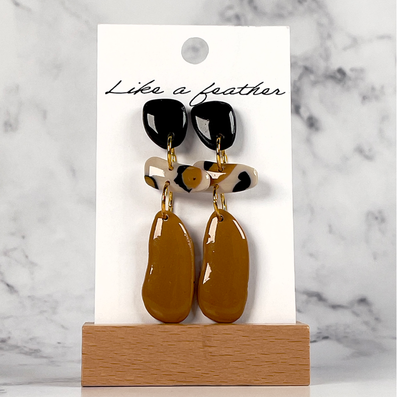 dangling earrings shaped like organic, in beige, black, sand