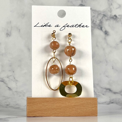 dangling earrings, in golden, beige, brown colors.