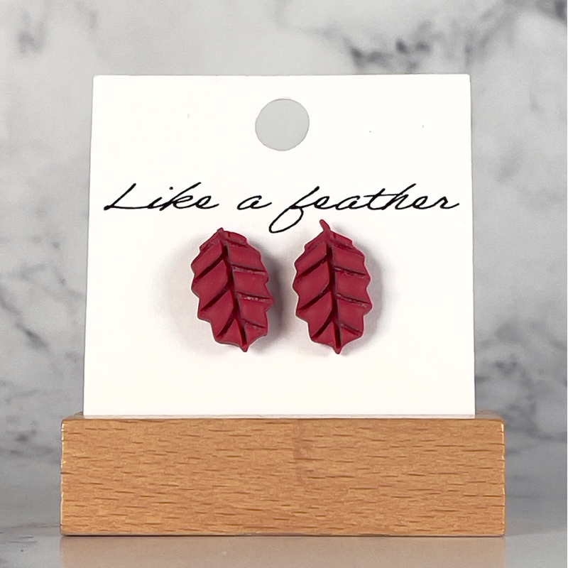 stud earrings shaped like leaf, in Burgundy color.