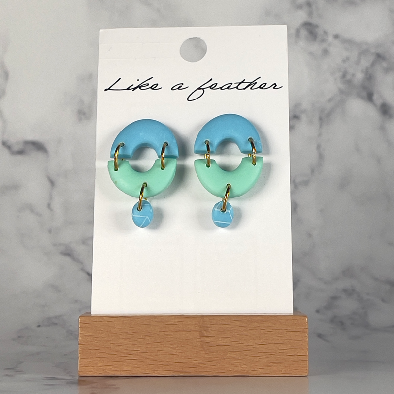 stud earrings shaped like two inverted rainbows, in pastel b