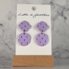 dangling earrings shaped like square and oval.