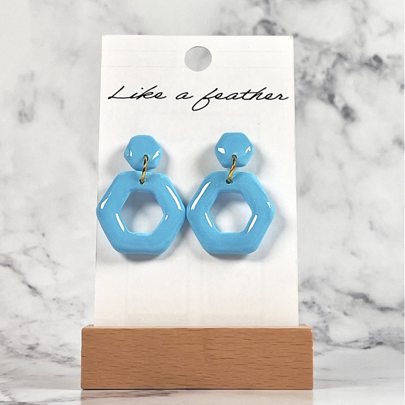 dangling earrings shaped like hexagone, in sky blue color.