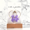 hoop earrings shaped like flower, in purple color.