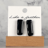stud earrings shaped like rectangle, in black color.